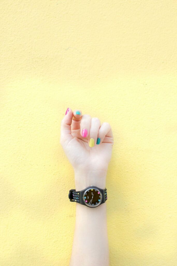 a womans hand wearing a watch