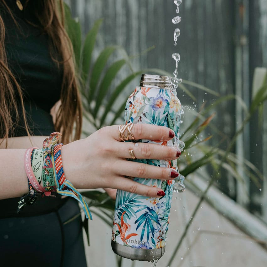 a-young-woman-holding-a-floral-stainless-steel-water-bottle-under-a-stream-of-water
