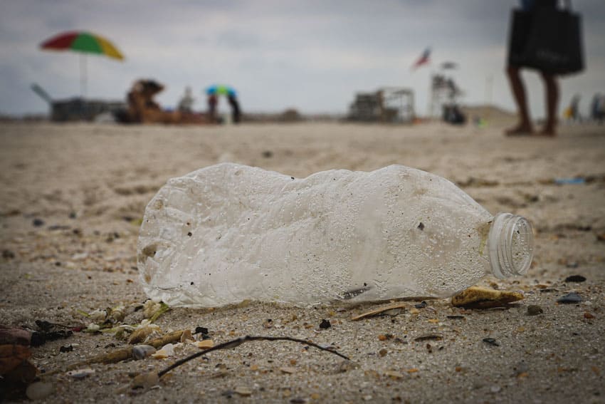 an-old-and-dirty-plastic-water-bottle-lying-on-the-ground-in-a-beach