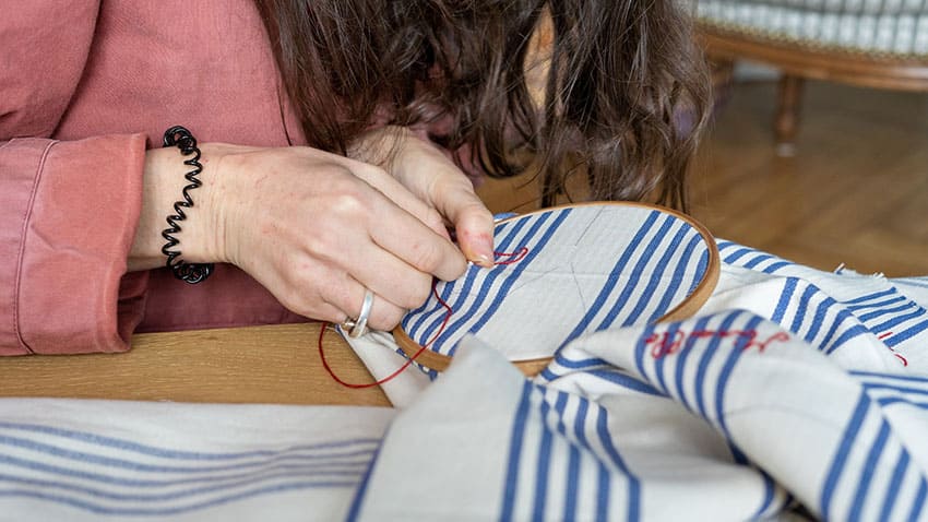 woman making embroidery art