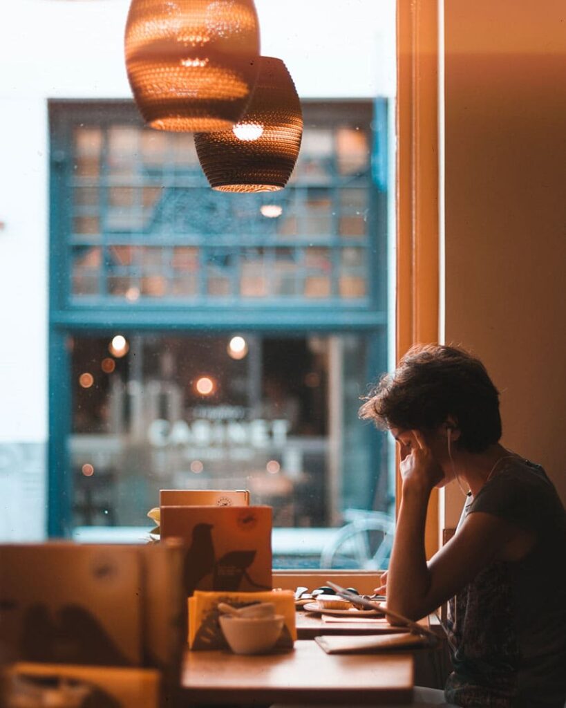 a female student studying at a cozy coffee bar