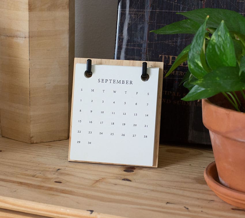a minimalistic calendar over a wooden surface