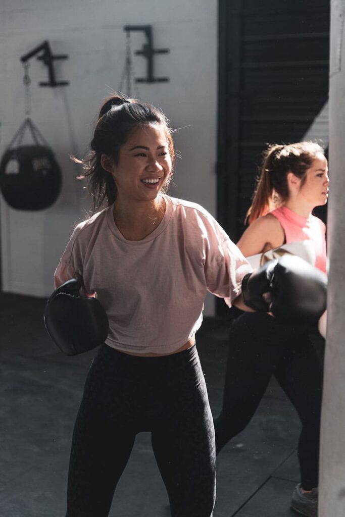 two young Asian women practicing boxing