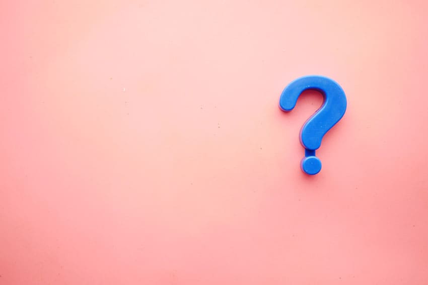 a blue 3D question mark over a pink background