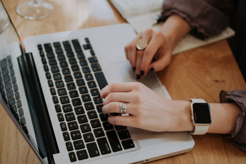 woman-typing-on-her-notebook how to sell low content books on etsy