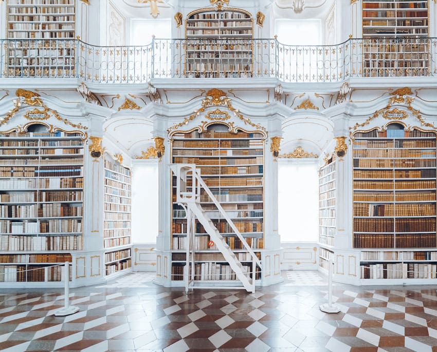 a-beautiful-library-with-golden-and-white-colors-and-big-windows