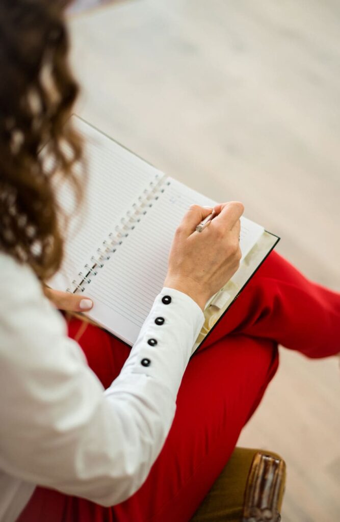 a-female-therapist-taking-down-notes-in-her-notebook
