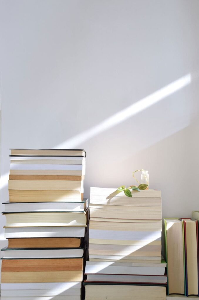 piles of books over a white background