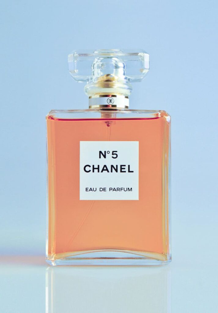 A Channel number 5 fragrance over a light blue background