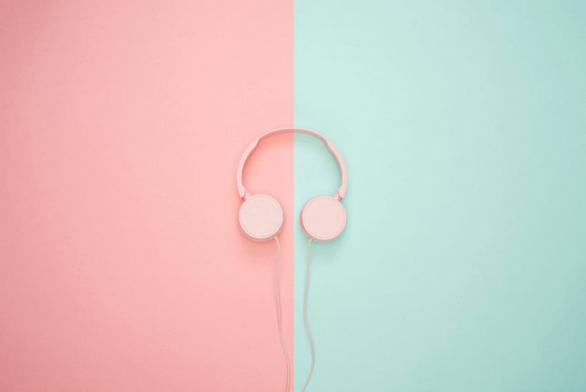 pink headphones over a light blue and pink background ASMR artist as one of the best beauty side hustles