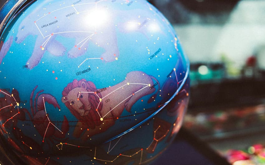 a globe showing zodiac constellations beauty astrologer as one of the best beauty side hustles