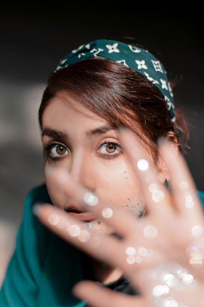 a woman showing the glitter on her hand and face glitter artist as one of the best beauty side hustles