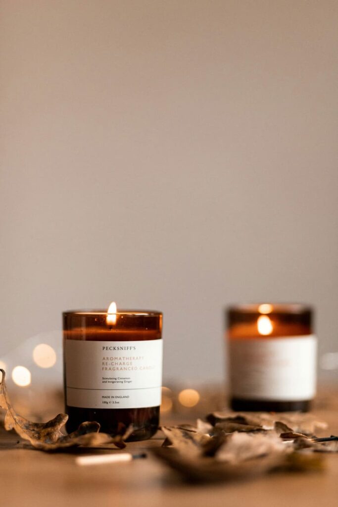 two 8 onze scented soy candles over a wooden table, cozy atmosphere candle seller as one of the best beauty side hustles