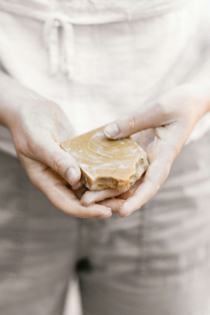 a woman holding a pumpkin soap