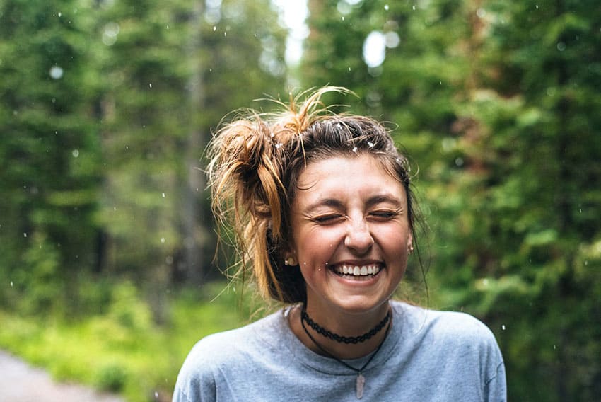 a woman laughing in the rain