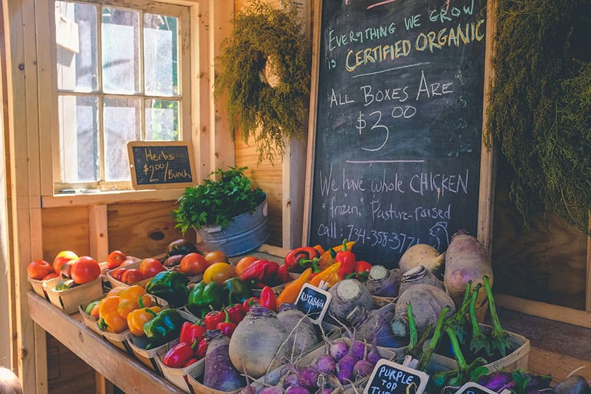 colorful veggies being sold in a farmer's market