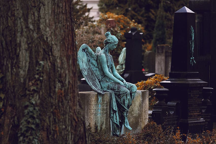 old angel statue in a cemetery setting