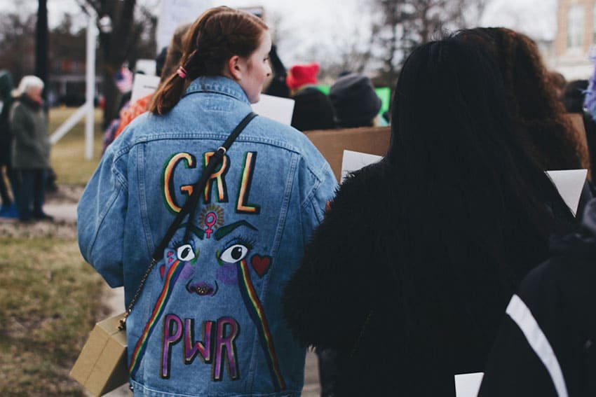 a woman wearing a jacket with a girl power stamp