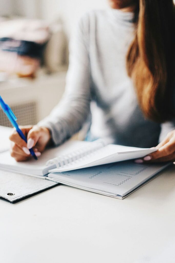 a woman organizing herself by using a planner