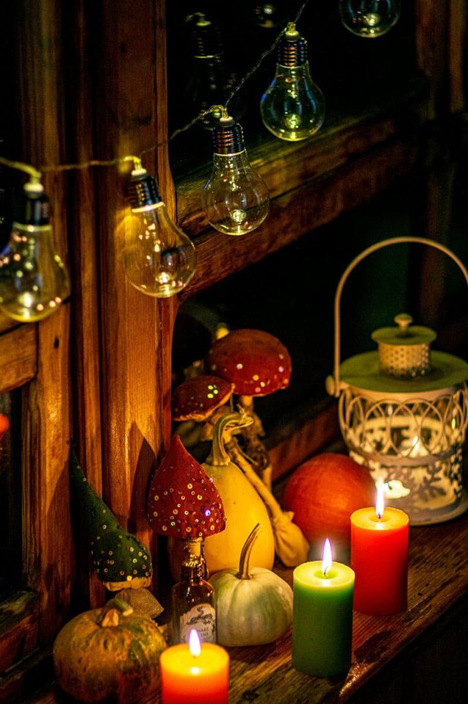 a cozy corner with colorful fake mushrooms, candles and liht bulb garland