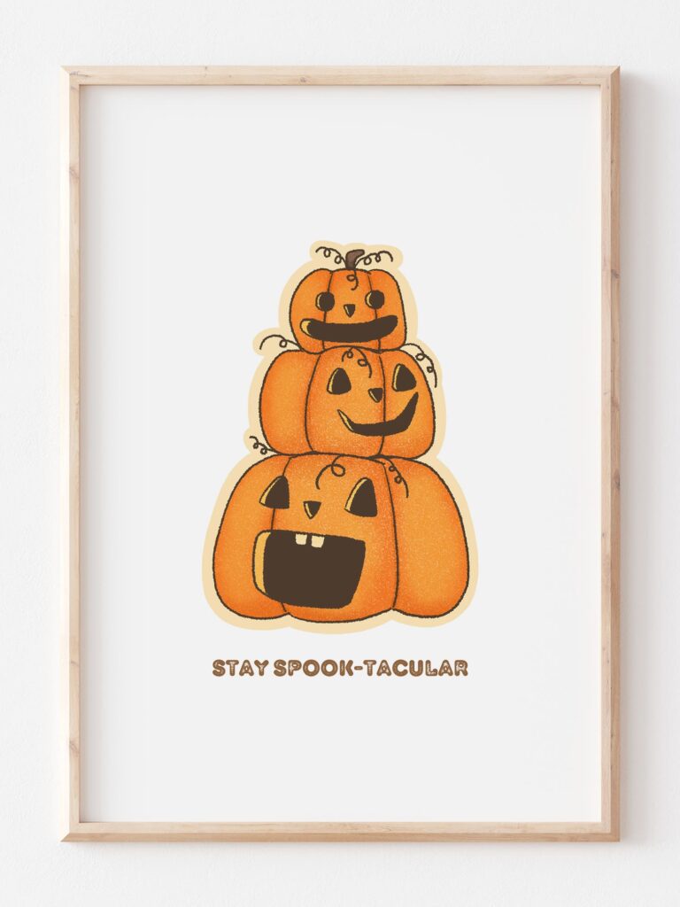 a print featuring three cartoony pumpkins and a message saying stay spook-tacular