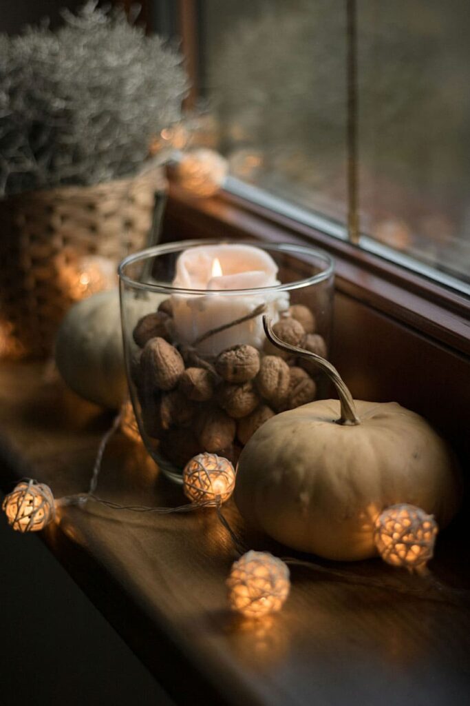 fall decoration made with pumpkins, garland, and candles cozy vibe