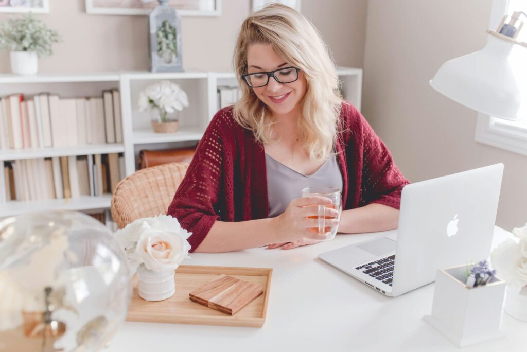a happy woman getting first client and working from bright home office