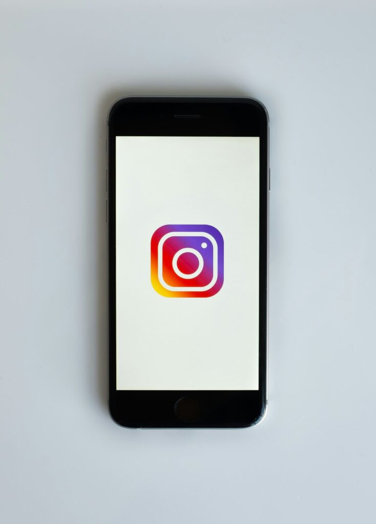 a cellphone showing instagram logo in the screen